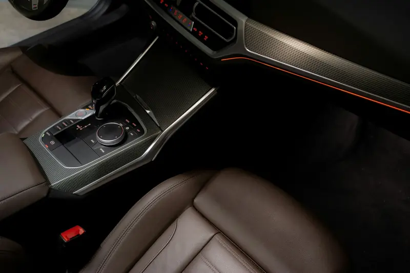 Clean brown leather seats and centre console inside a modern car